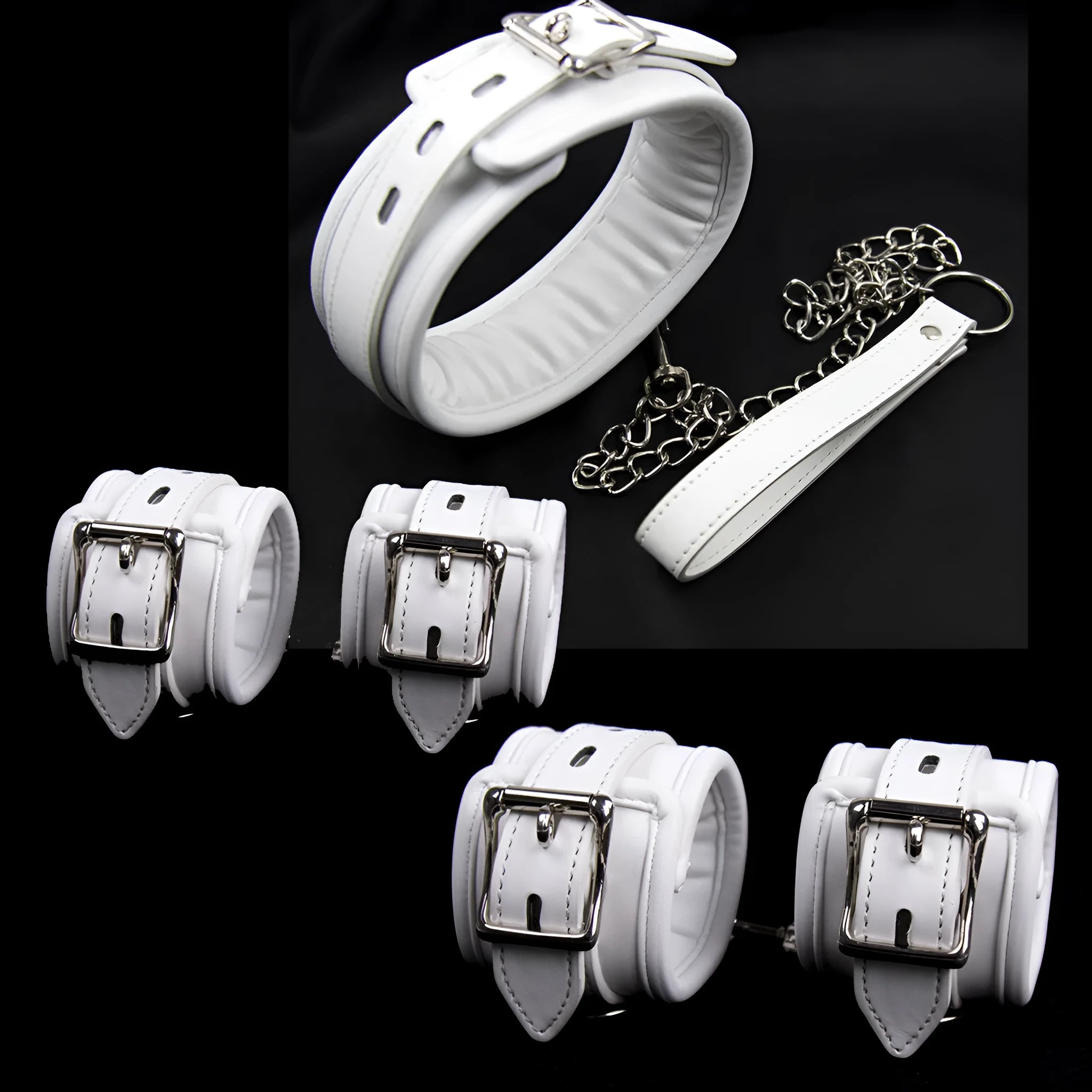 White PU sponge bondage restraint set showing handcuffs, foot cuffs, and a neck scarf on a dark surface.