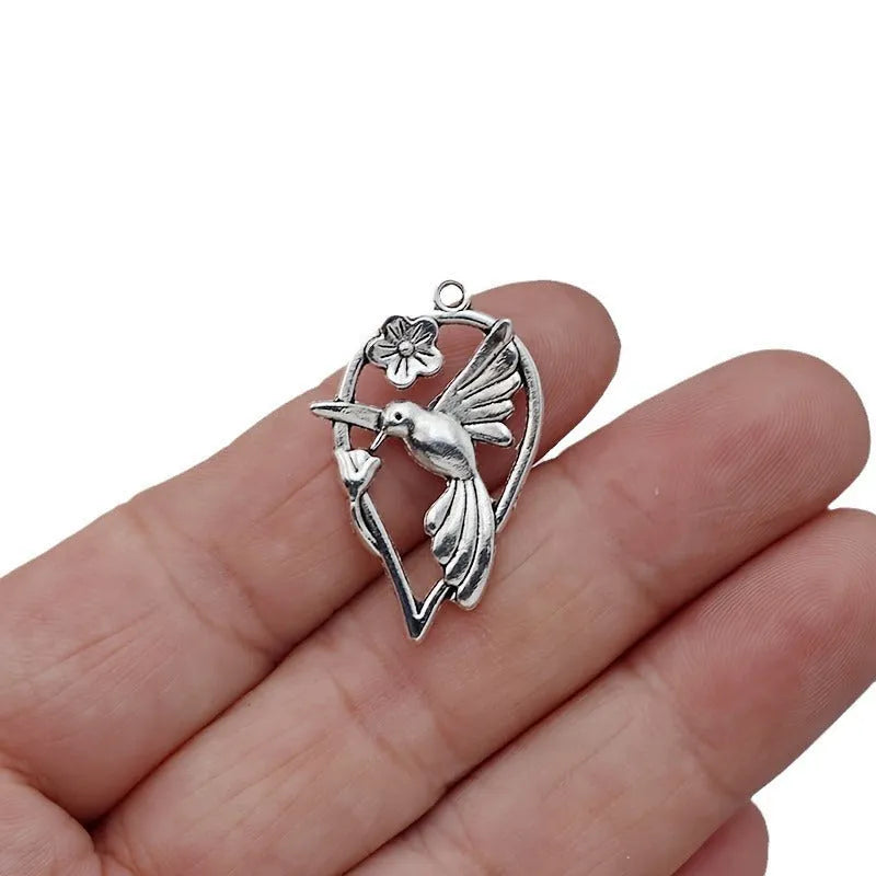 Alloy magpie pendant charm with electroplated finish in colour P234 for DIY jewellery crafting.