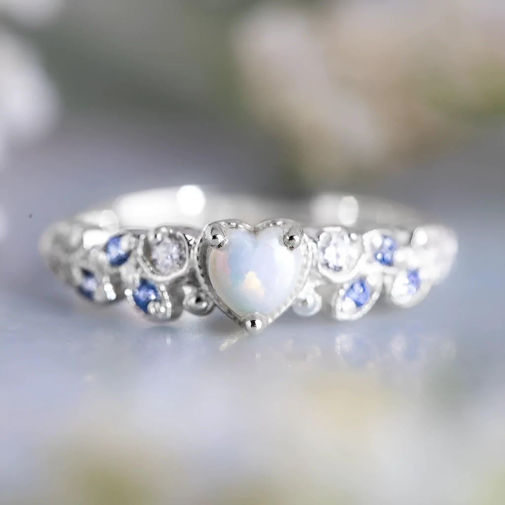 Women's white alloy heart ring with a detailed floral and opal ocean pattern.
