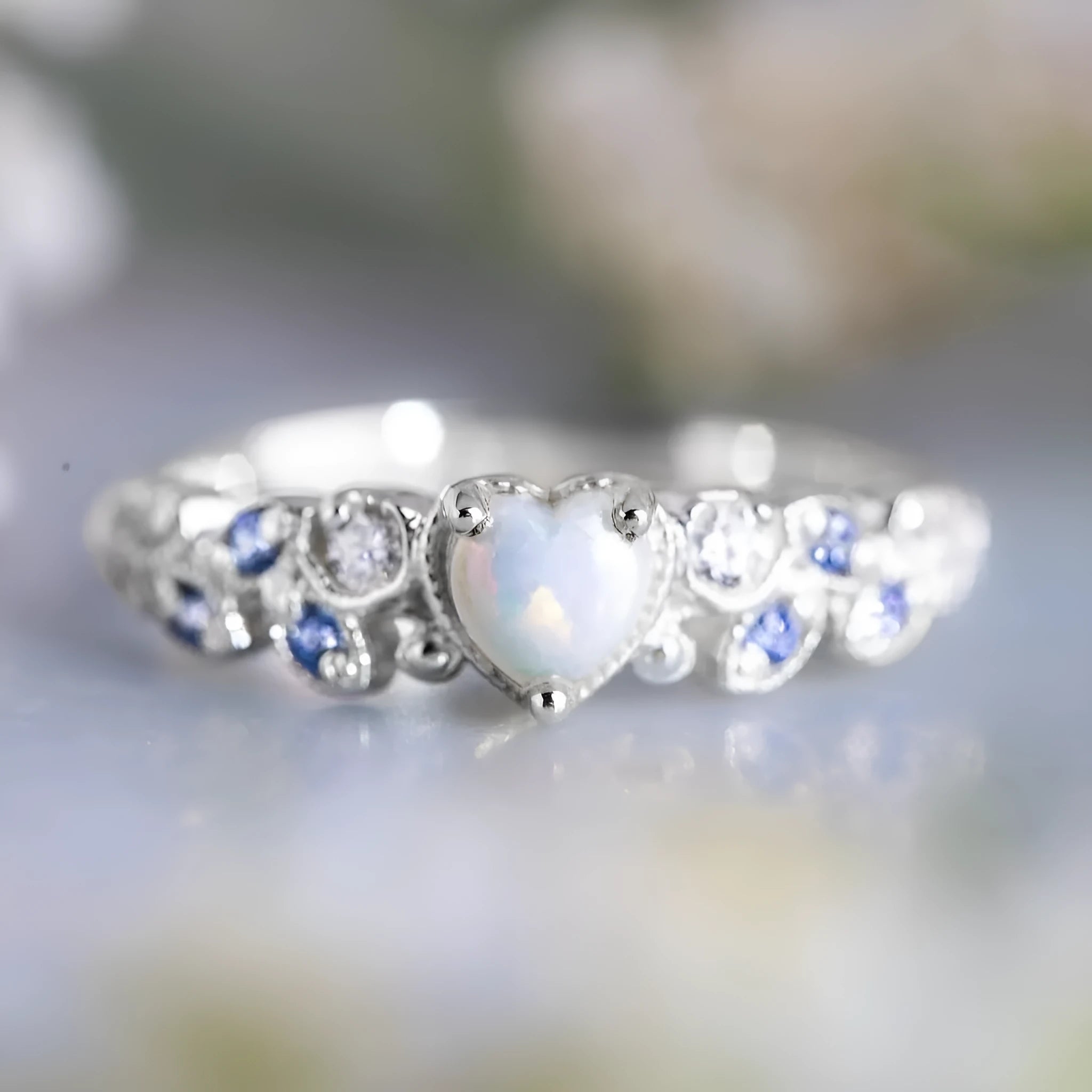 Women's white alloy heart ring with a detailed floral and opal ocean pattern.