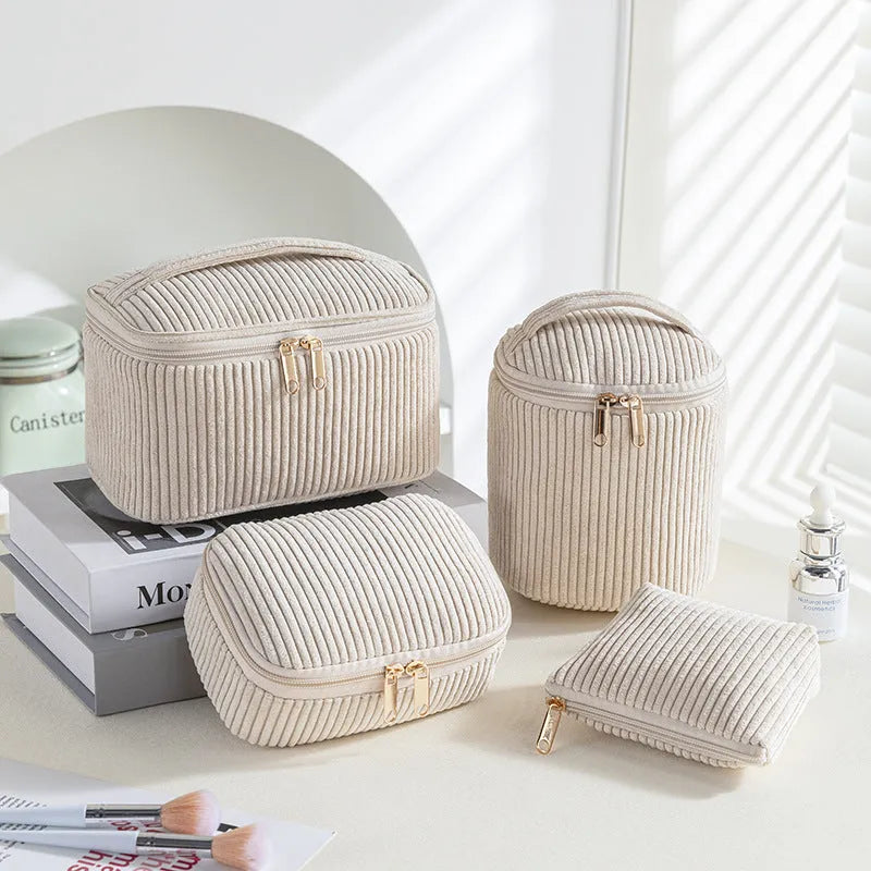 Four cube-shaped flannelette makeup bags in a set, showing pink dots and solid colour options.