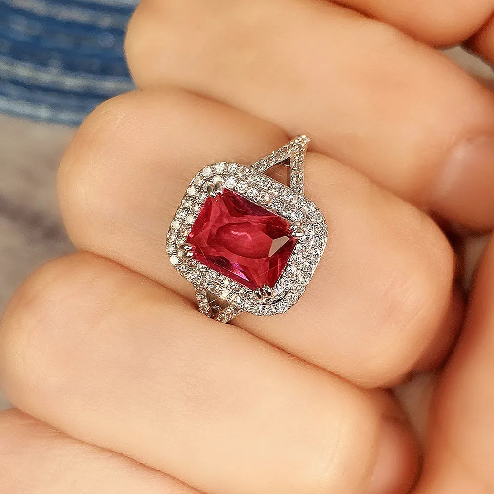 Red copper square women's ring with a central rhinestone on a model's hand.
