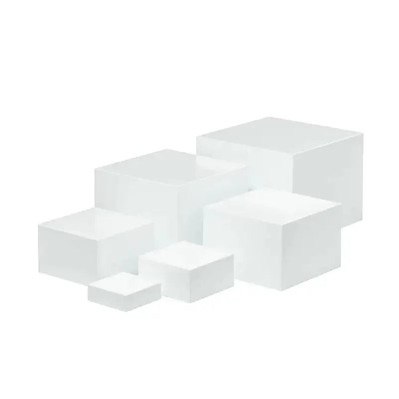 White and transparent plastic suit cube dessert display stands arranged in a tiered formation.