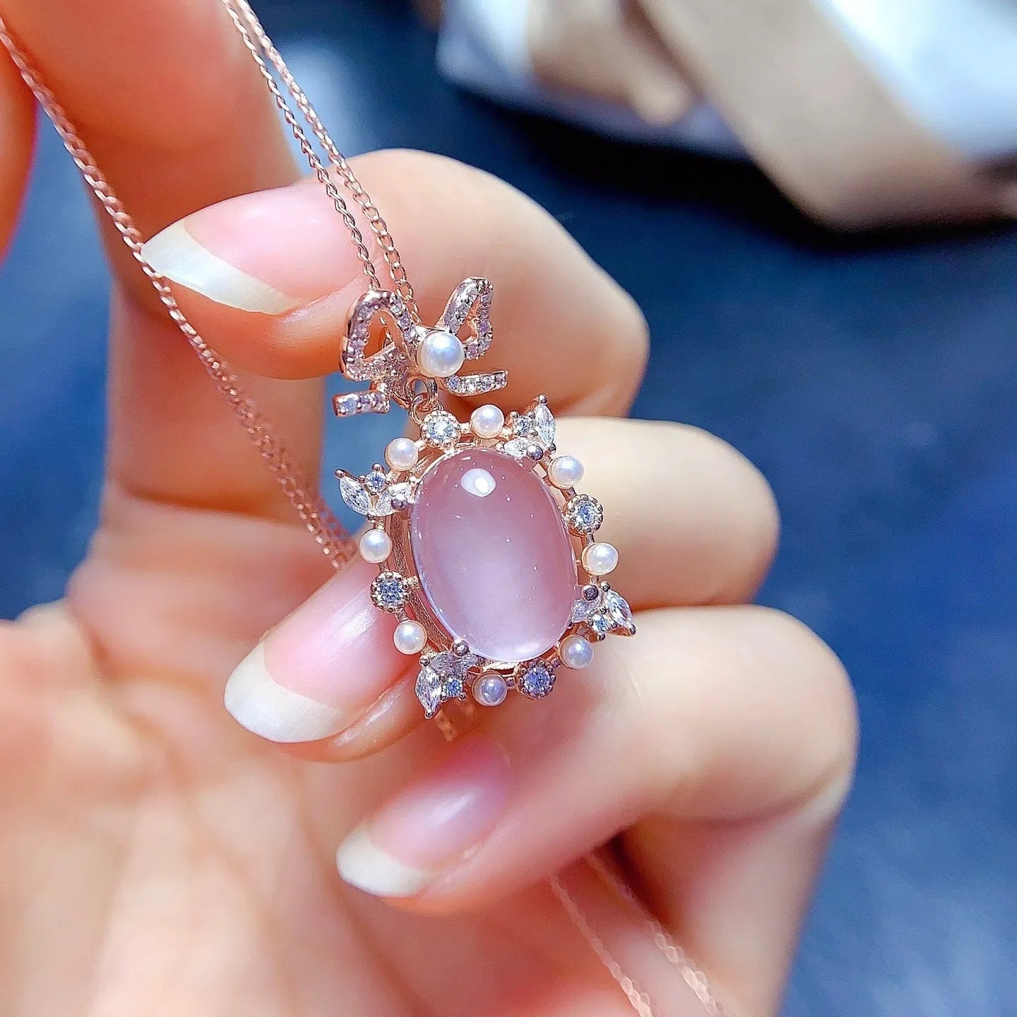 Rose quartz geometric pendant on a silver chain with rose gold plating.