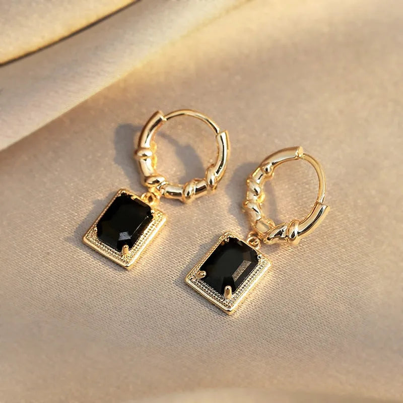 A pair of black geometric quadrilateral zircon earrings with a French Court retro design on a white background.