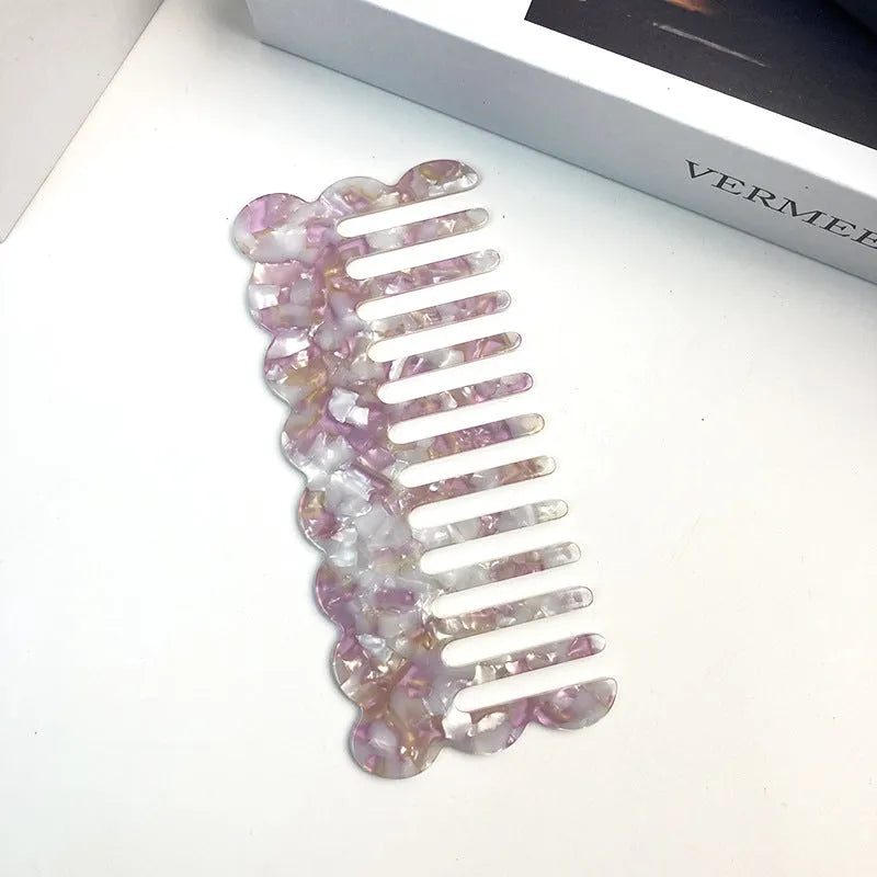 Acetate board hair comb with geometric wave design in a selection of colours.