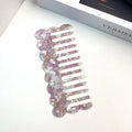 Acetate board hair comb with geometric wave design in a selection of colours.