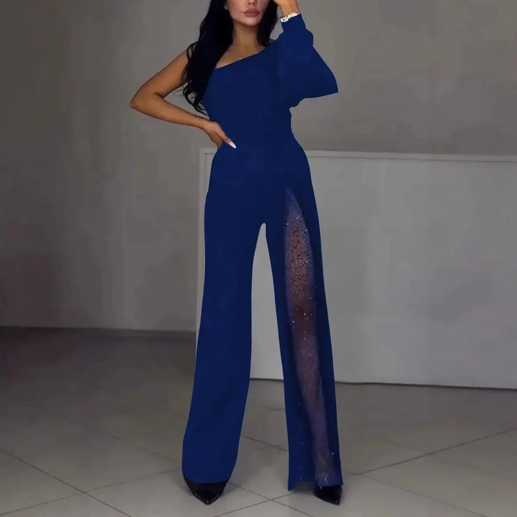 A woman modelling a black, long-sleeve polyester jumpsuit with a high leg slit and mid-waist design.