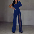 A woman modelling a black, long-sleeve polyester jumpsuit with a high leg slit and mid-waist design.