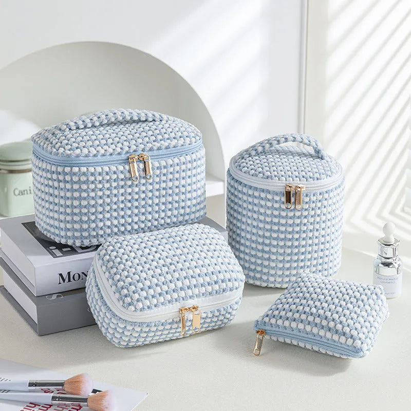 Four cube-shaped flannelette makeup bags in a set, showing pink dots and solid colour options.