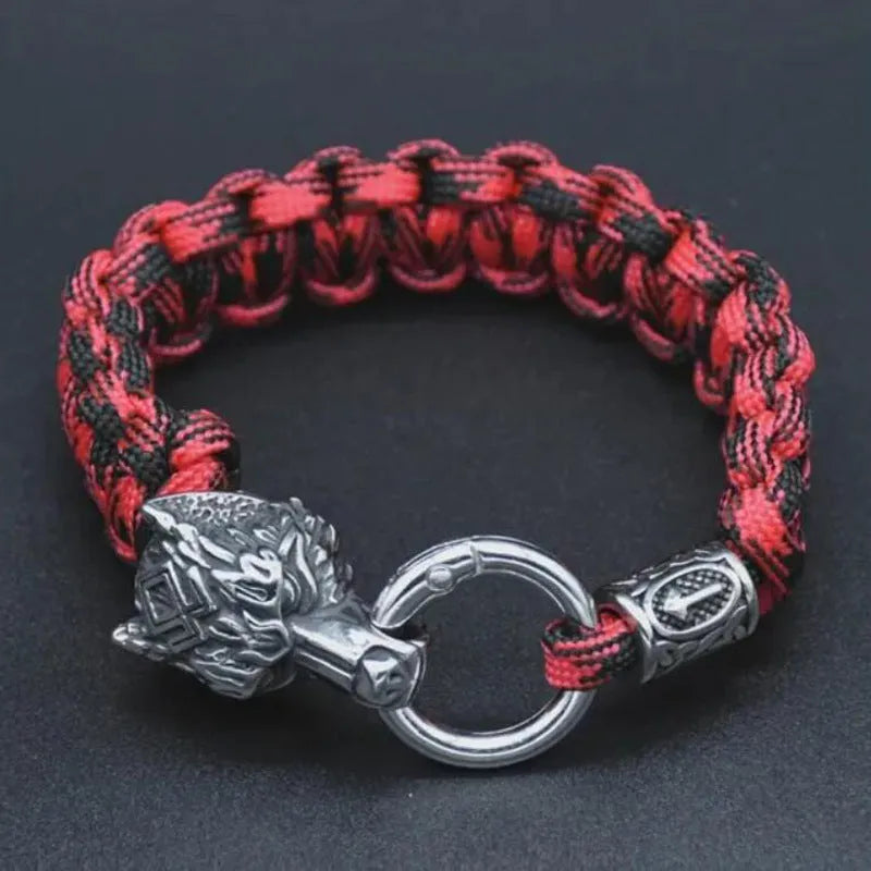 Handmade titanium steel wolf head bracelet in camouflage colour on a wrist.