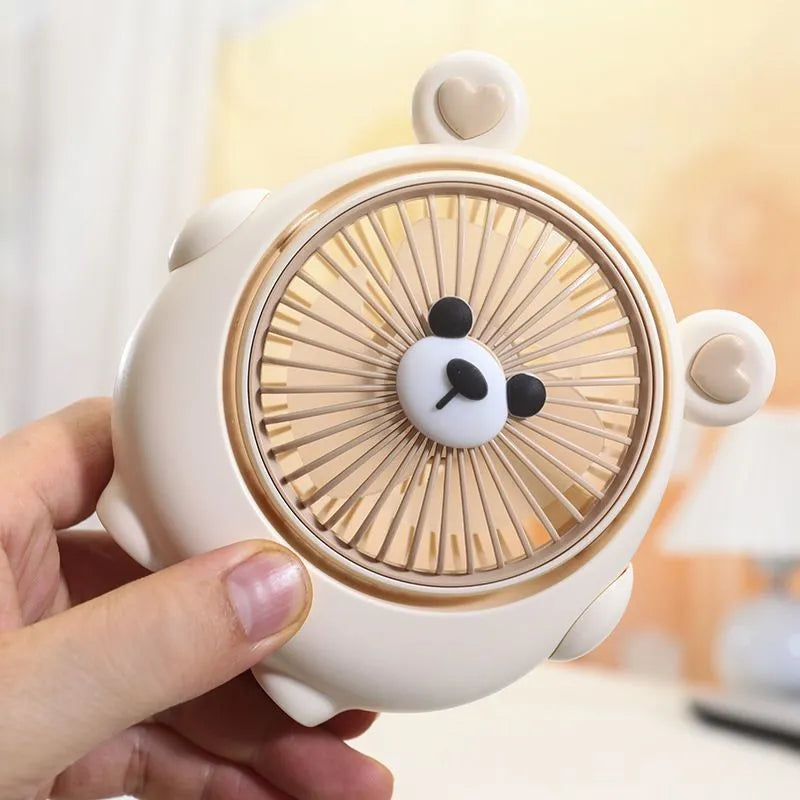 Cute dog-themed USB desktop electric fan on a wooden desk, showing three-speed buttons and a light pink puppy design.