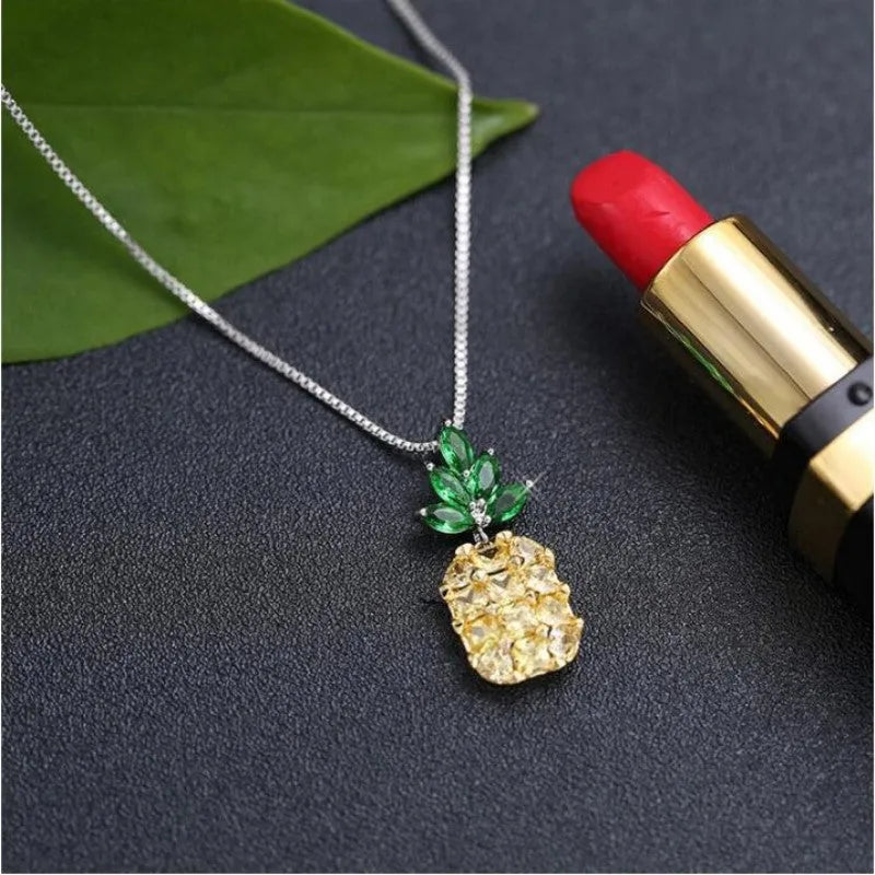 Silver geometric pineapple fruit pendant on a women's fashion necklace.