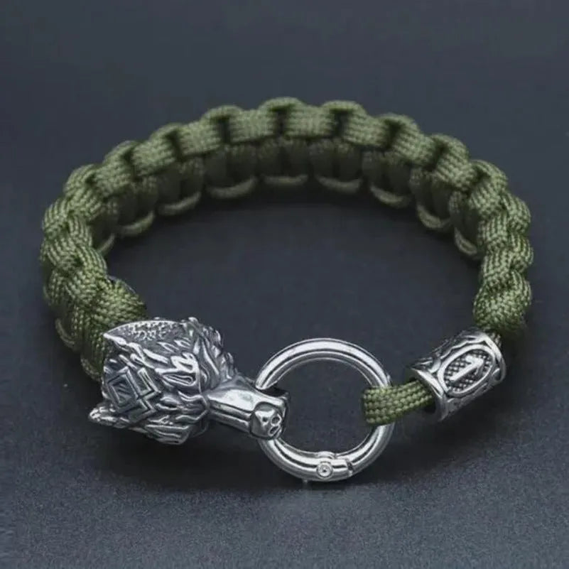 Handmade titanium steel wolf head bracelet in camouflage colour on a wrist.