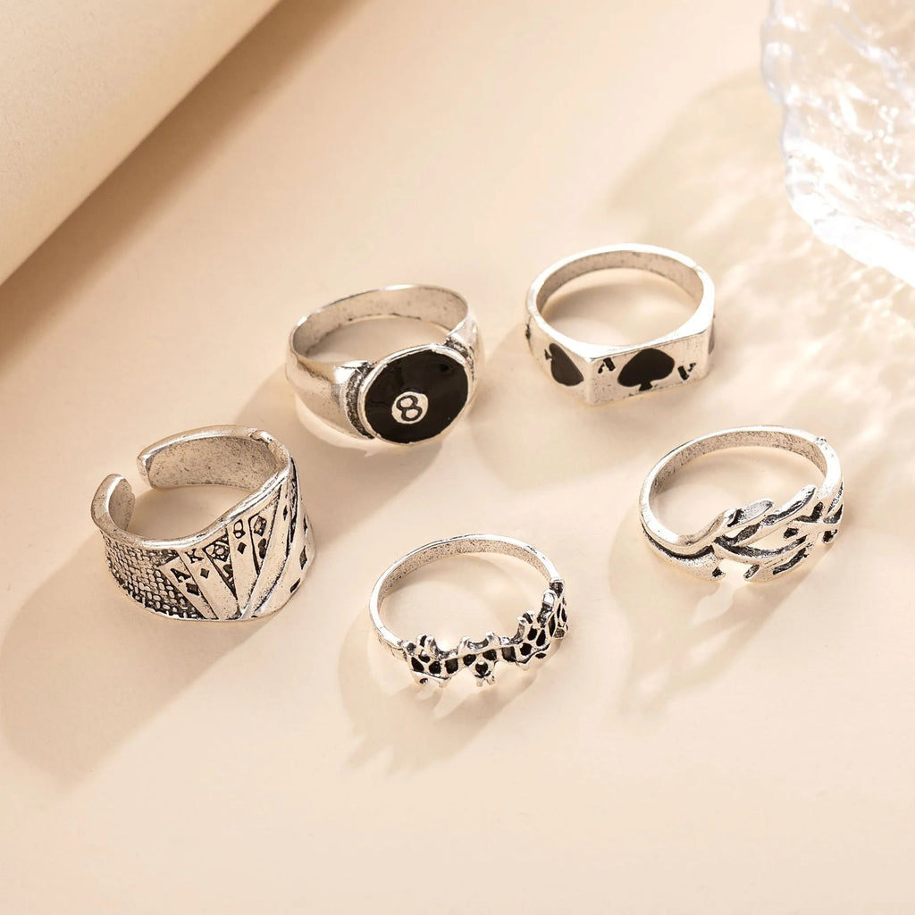 Black alloy poker ring with a retro spade card design on a finger.