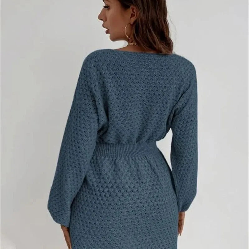 Blue women's knitted dress with crochet flower detail and a fitted waist.