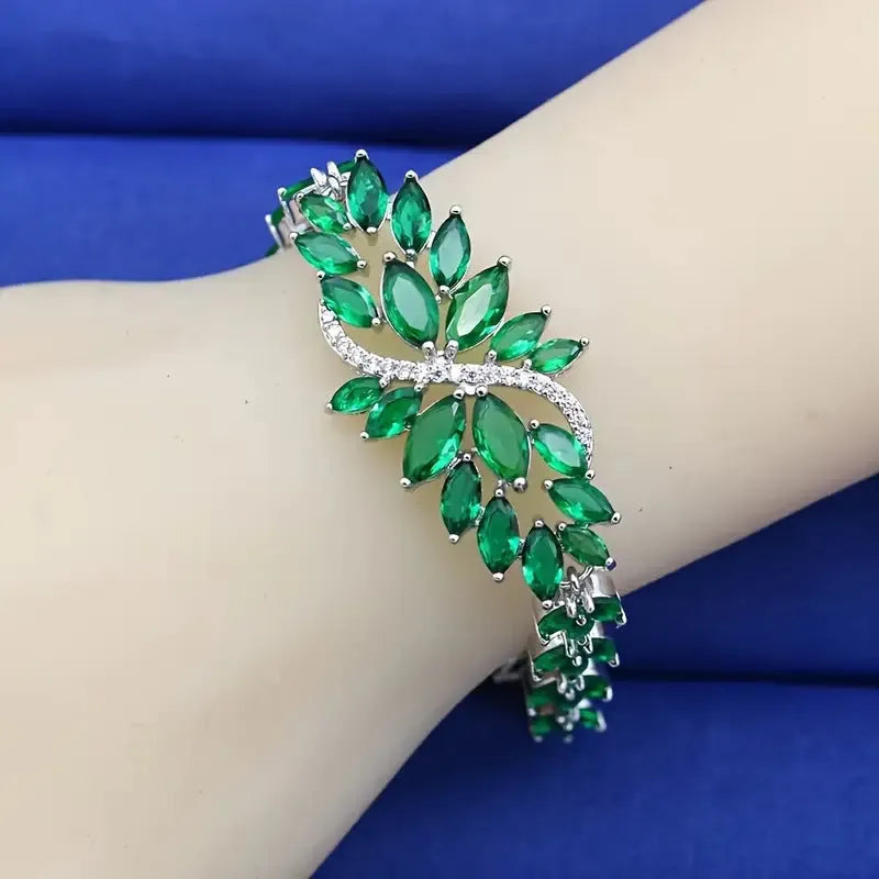 Gold electroplated copper bracelet with ice flower design and blue zircon stones