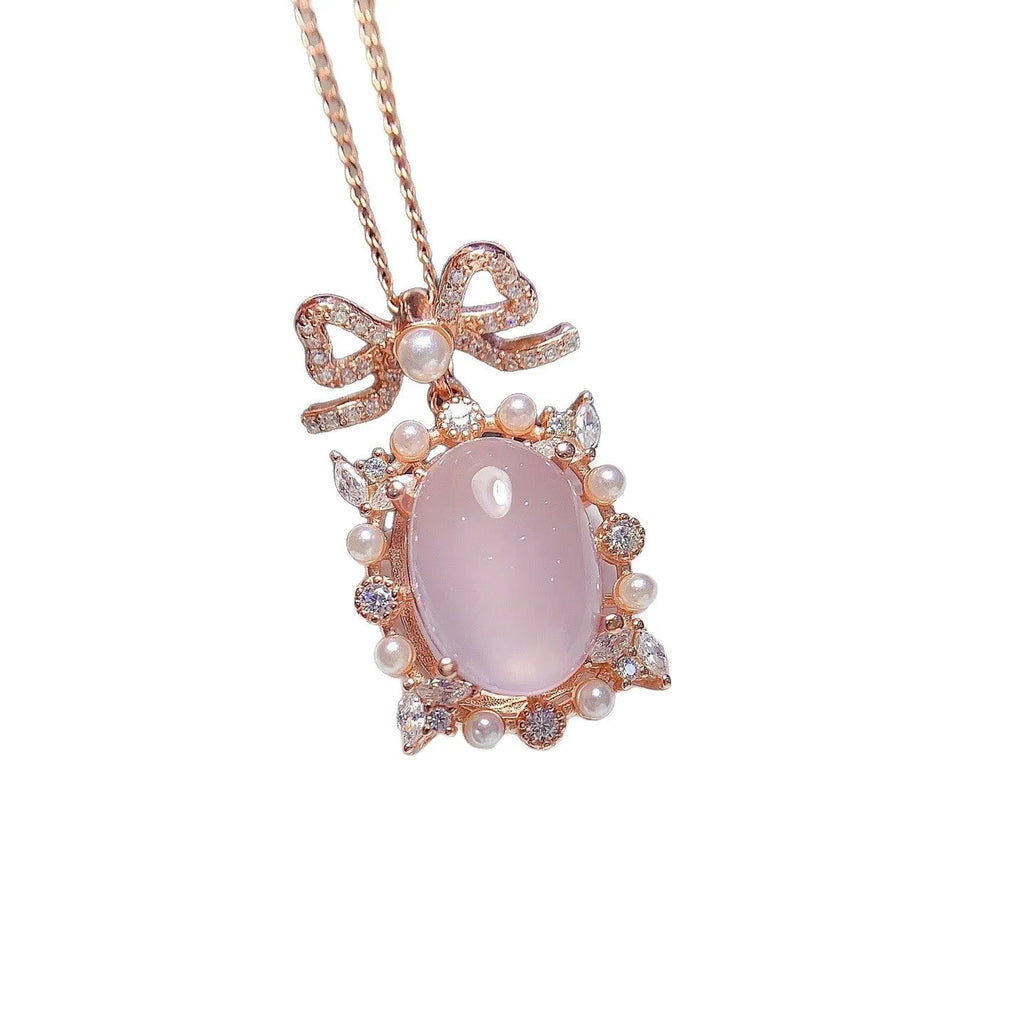 Rose quartz geometric pendant on a silver chain with rose gold plating.