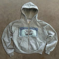 A loose-fitting unisex hoodie jacket with a front zipper, hood, and zip pockets, featuring a letter print.