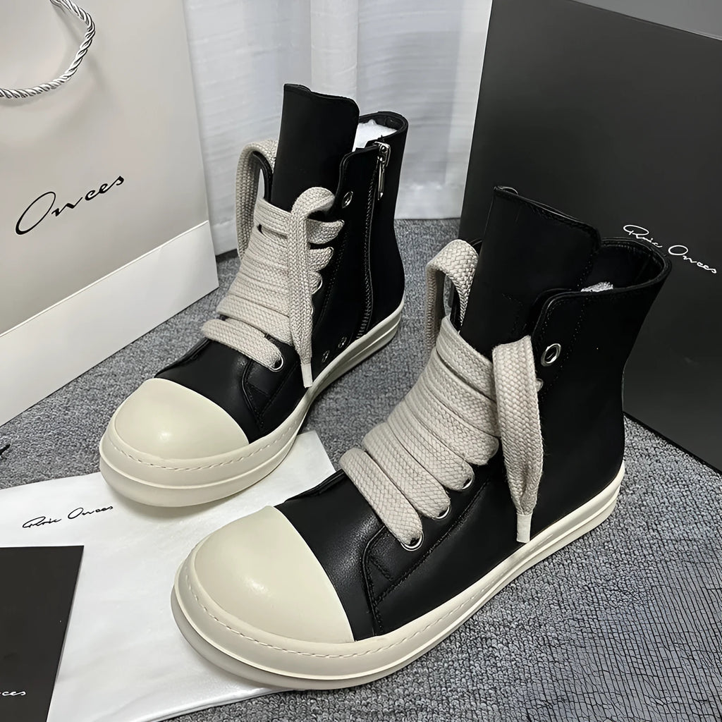 Genuine leather high-top sneakers with side zipper in black, shown on a white background.