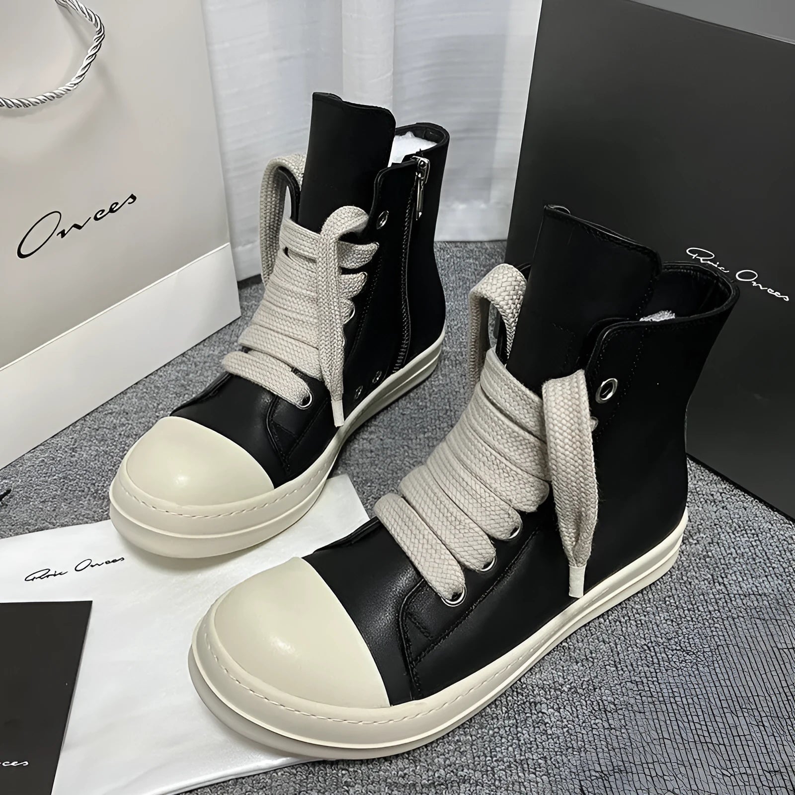 Genuine leather high-top sneakers with side zipper in black, shown on a white background.