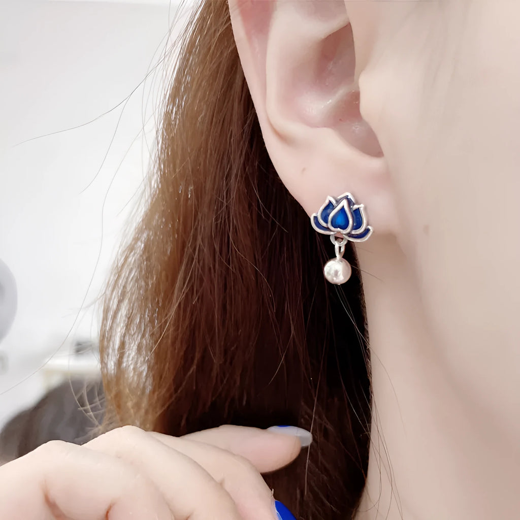 Blue lotus flower ear studs with seedpod tassel detail, silver alloy construction.