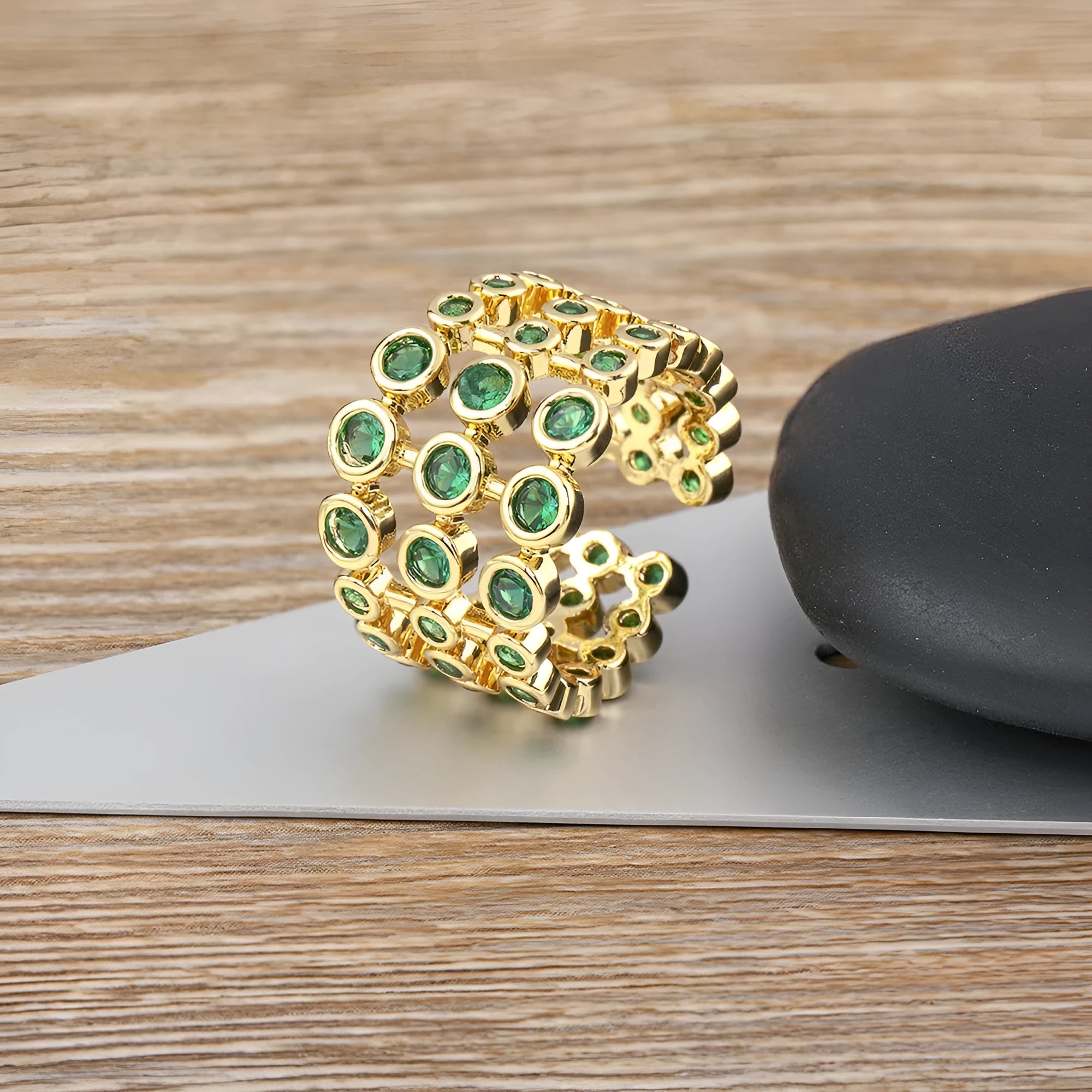 Wide copper ring with layered gold plating and green zircon stones
