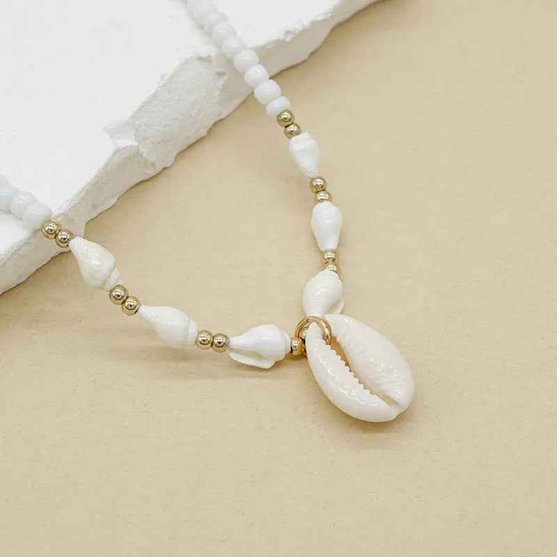 White electroplated shell necklace with mother pearl conch pendant on regular chain