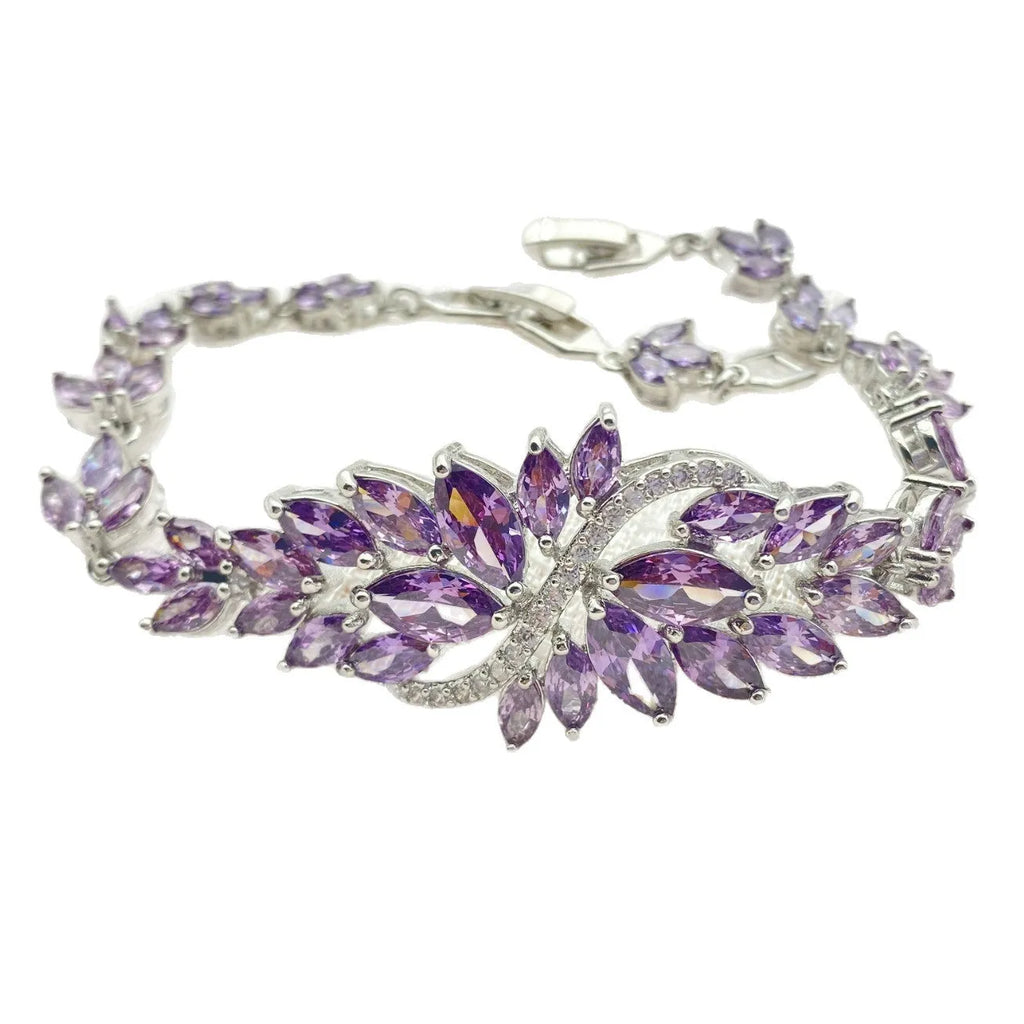 Gold electroplated copper bracelet with ice flower design and blue zircon stones