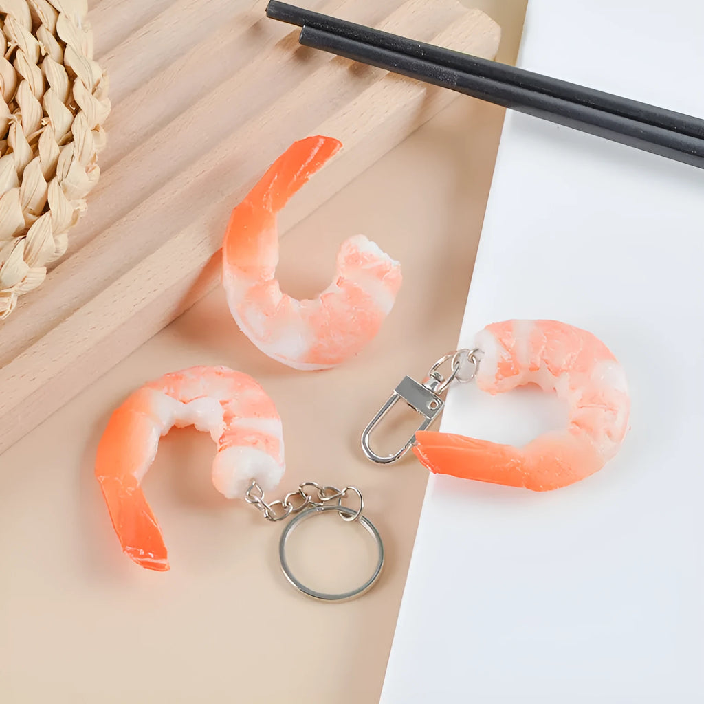 PVC shrimp-shaped keychain with metal door buckle, showing detailed crustacean design.