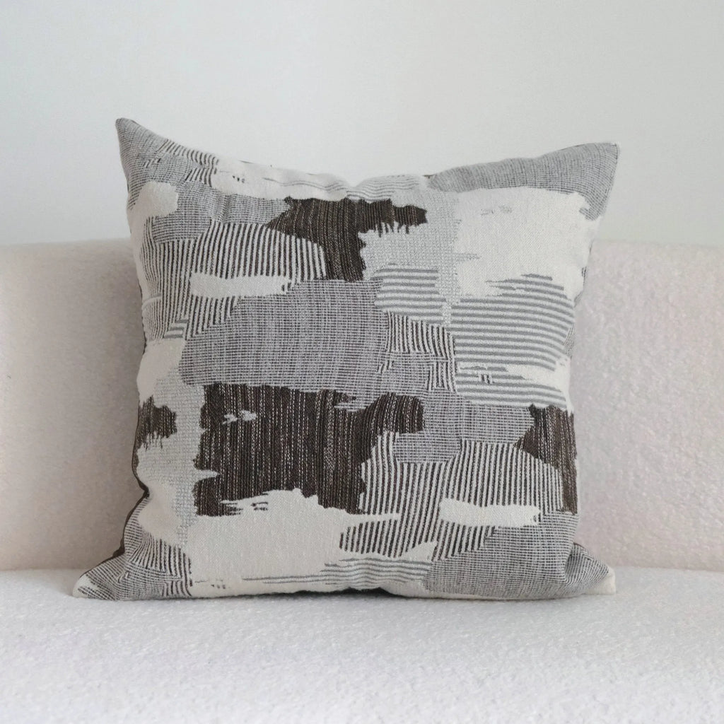 Coffee brown Chinese classical style cushion with striped and patchwork designs on a sofa.