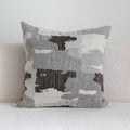 Coffee brown Chinese classical style cushion with striped and patchwork designs on a sofa.