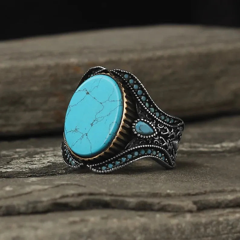 Men's round turquoise ring with antique silver metal band, shown in size 10.