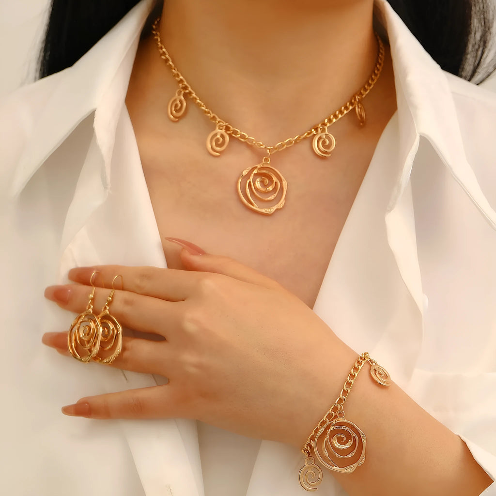 Spiral donut design women's jewellery set showing necklace, bracelet and ear hooks in gold or silver finish