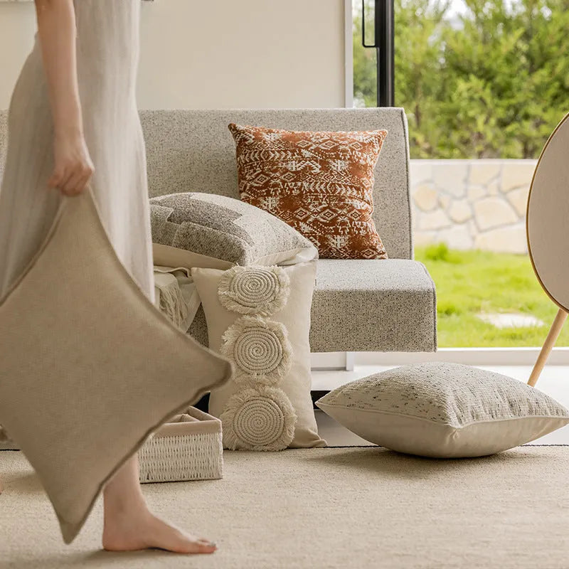 Coreless pillow cushion with pp cotton filler in solid colours on a sofa.