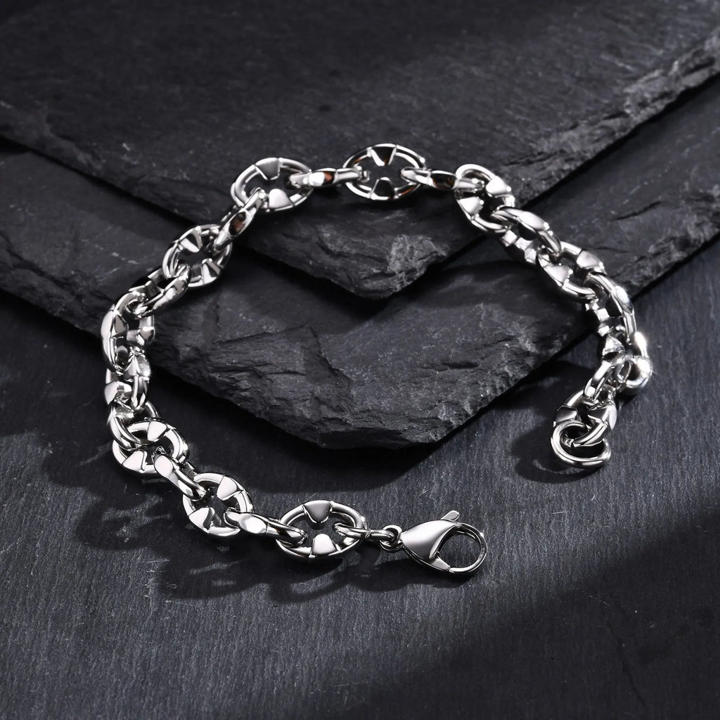 A thick stainless steel chain bracelet with geometric links, shown in a steel colour.
