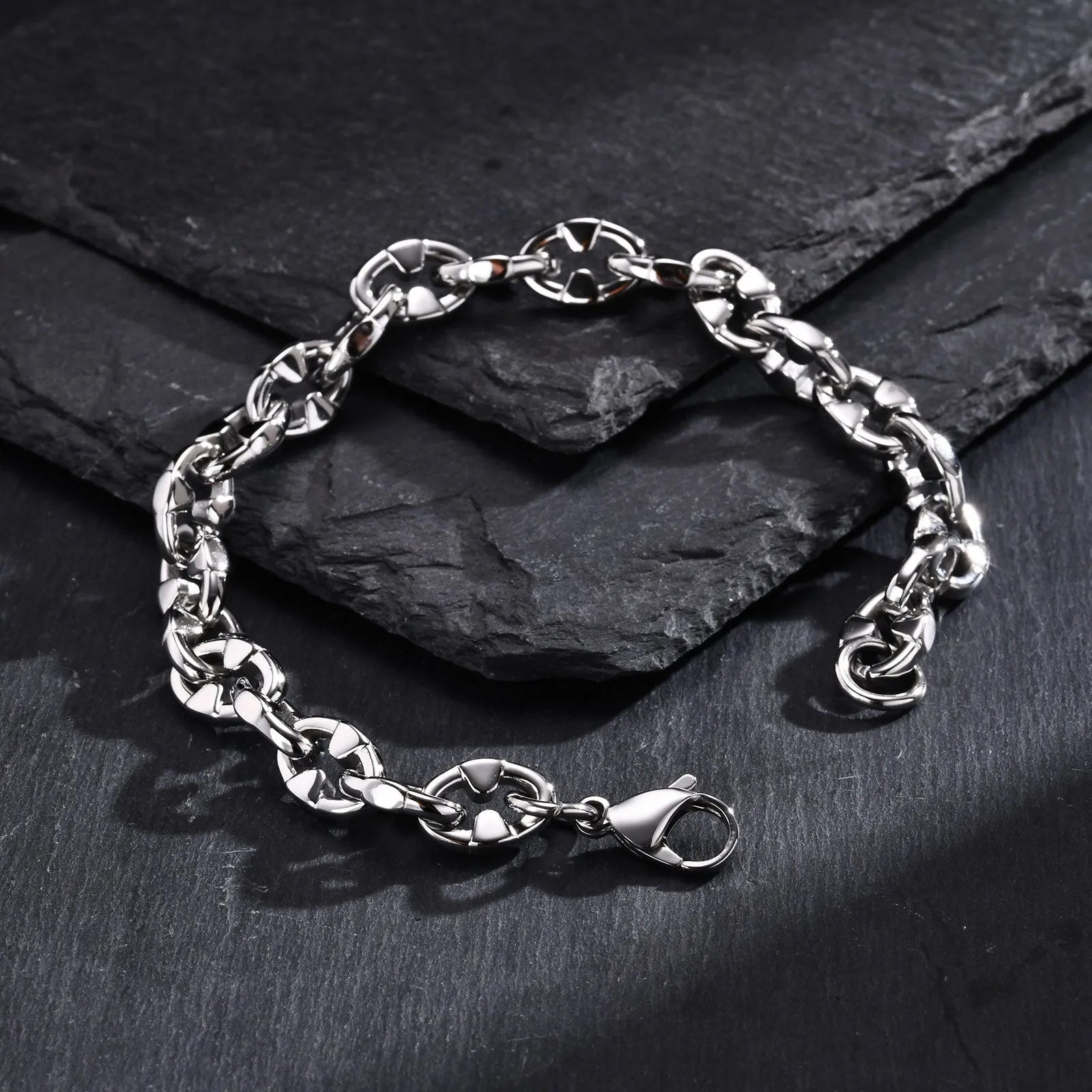 A thick stainless steel chain bracelet with geometric links, shown in a steel colour.