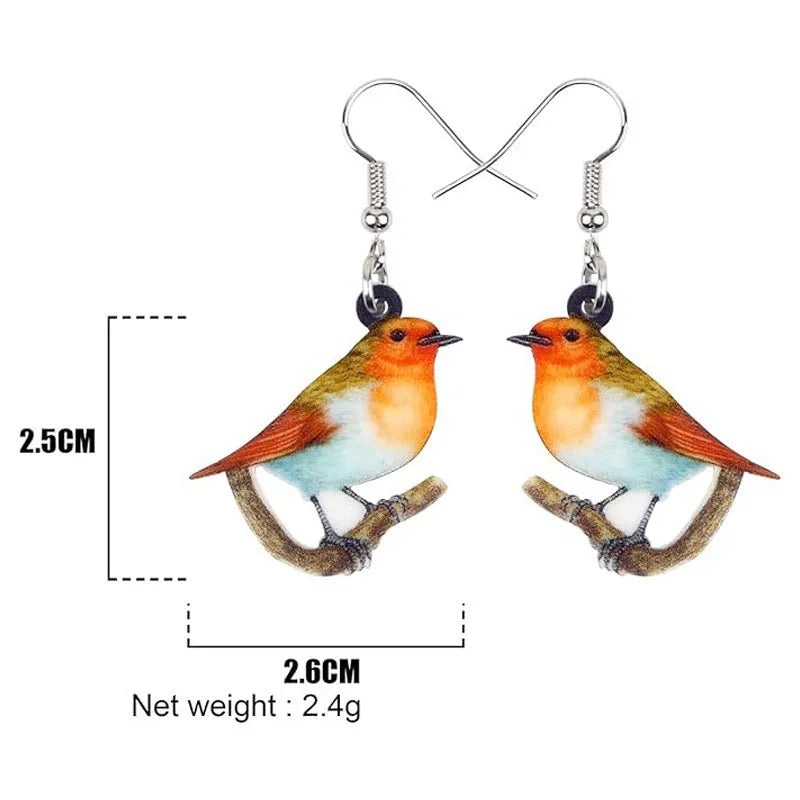 A pair of blue titmouse pendant earrings with printed design on acrylic, featuring geometric and snake elements.