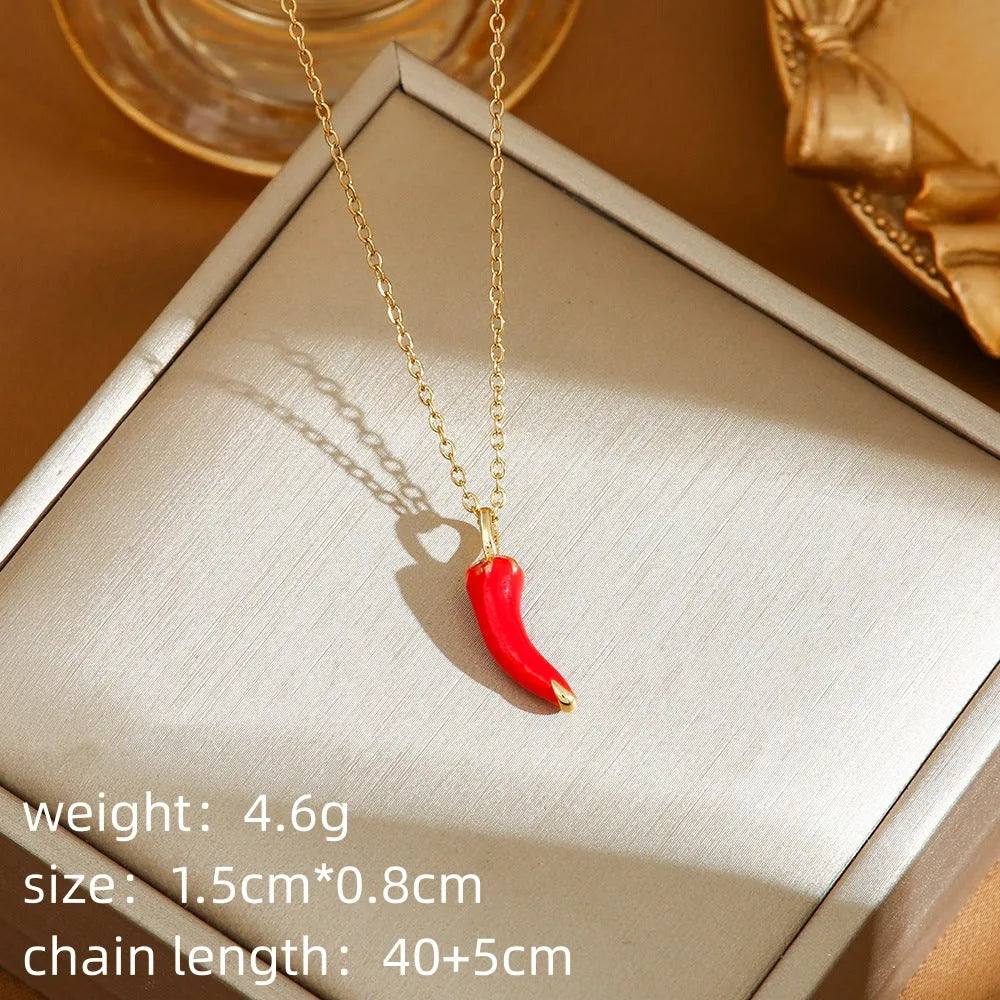 Close-up of a titanium steel necklace with an indie-style cherry pendant on an O-ring chain.