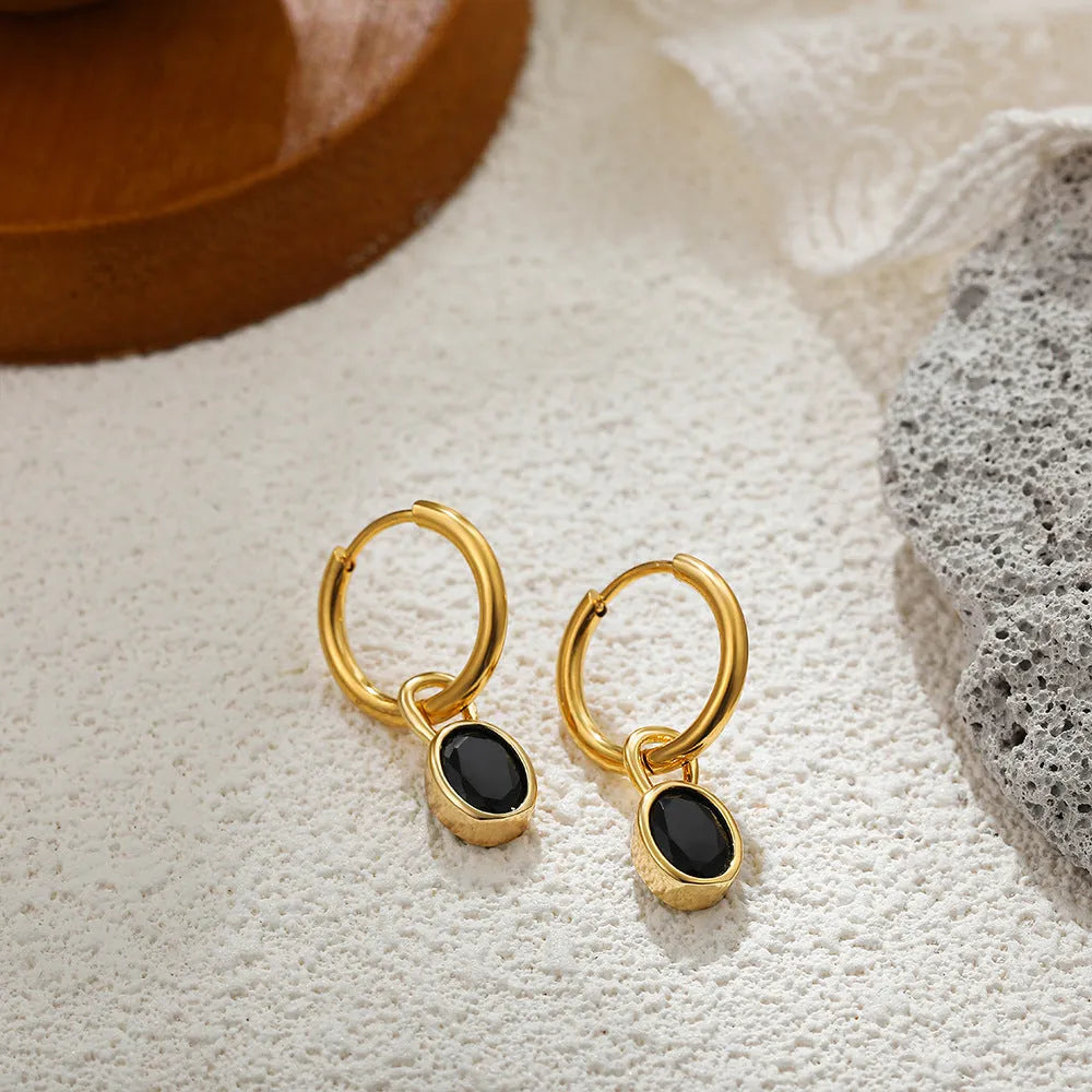 A pair of women's retro-style oval zircon stud earrings in copper, showing one of the six available stone colour options.