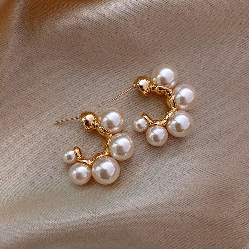 A pair of red bell-shaped alloy earrings for women on a plain background.