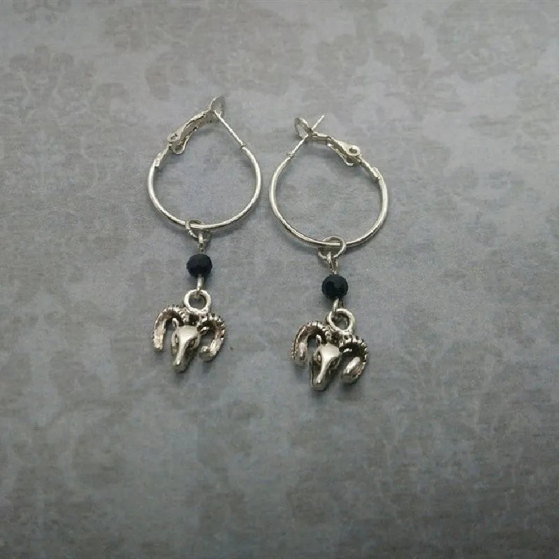 A pair of silver-coloured alloy round ring earrings featuring a Tibetan antelope design.