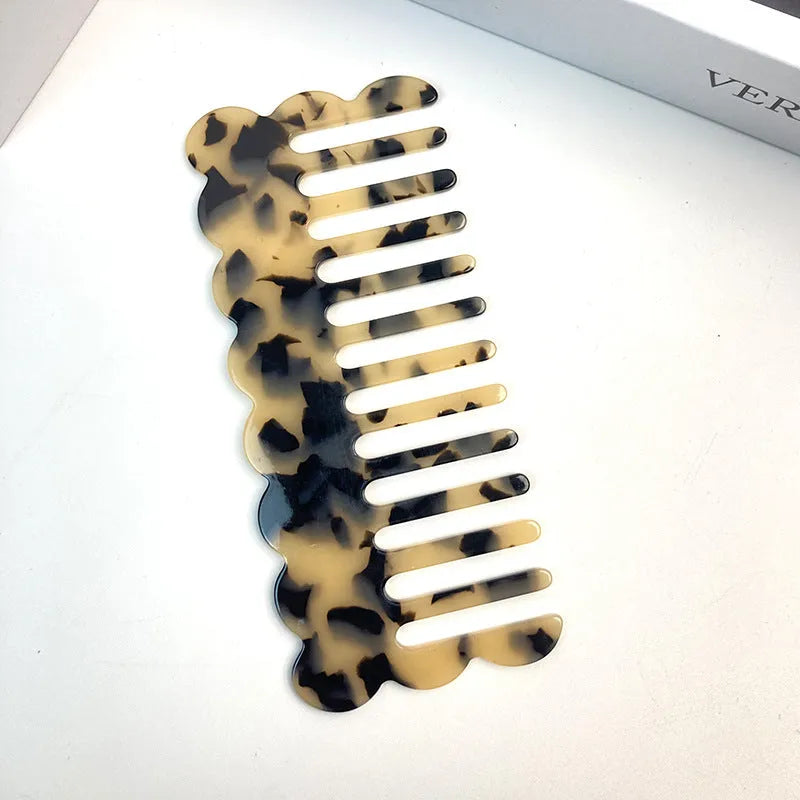 Acetate board hair comb with geometric wave design in a selection of colours.