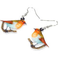 A pair of blue titmouse pendant earrings with printed design on acrylic, featuring geometric and snake elements.