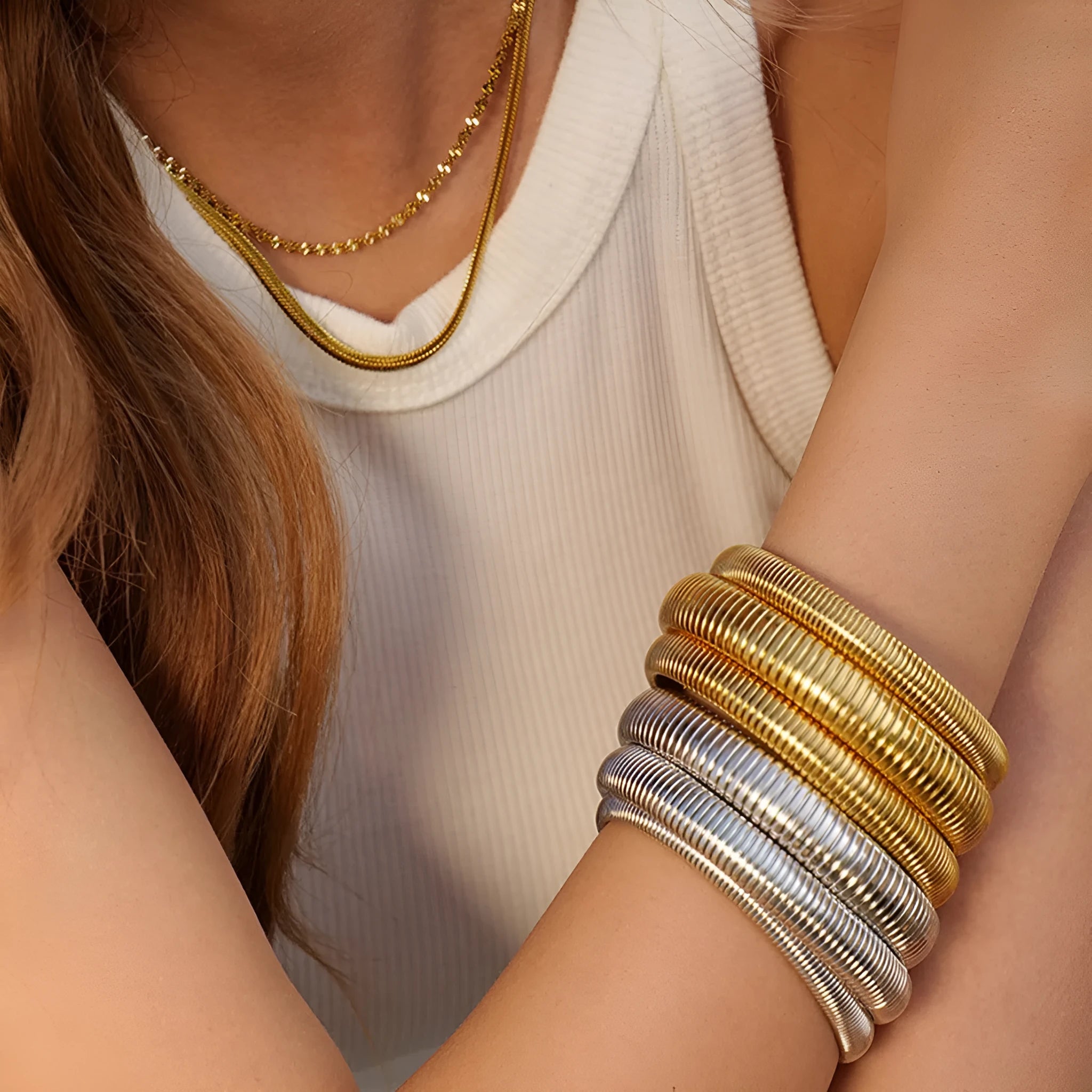 Women's titanium steel bracelet with vertical stripe pattern in gold or silver, available in 0.8cm to 2.0cm widths