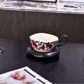 Antique style ceramic coffee cup and saucer set in retro black or orange colour.