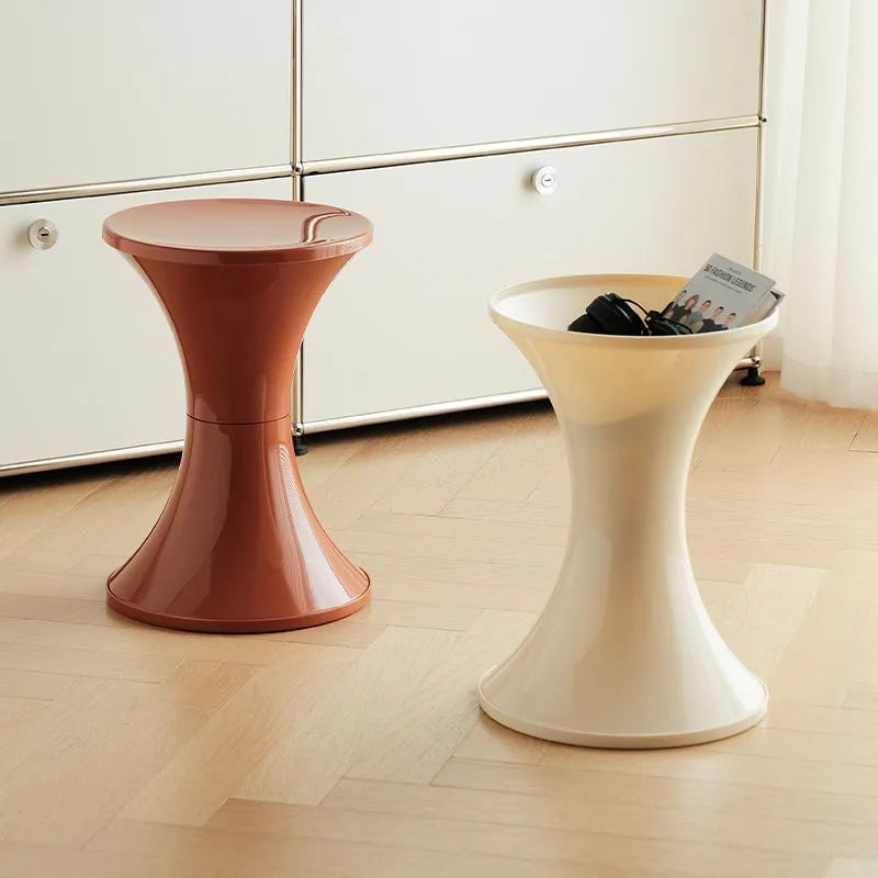 Creative hourglass-shaped plastic stool for changing shoes, shown in a green colour.