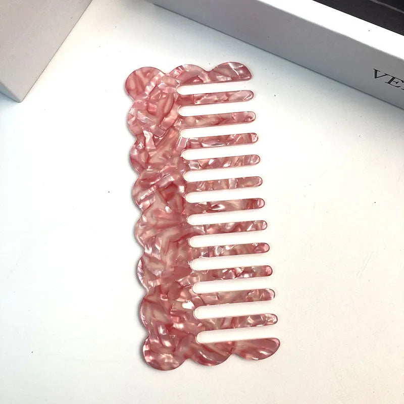 Acetate board hair comb with geometric wave design in a selection of colours.