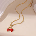 Women's strawberry fruit pendant necklace in red and white gradient colours on an alloy chain.