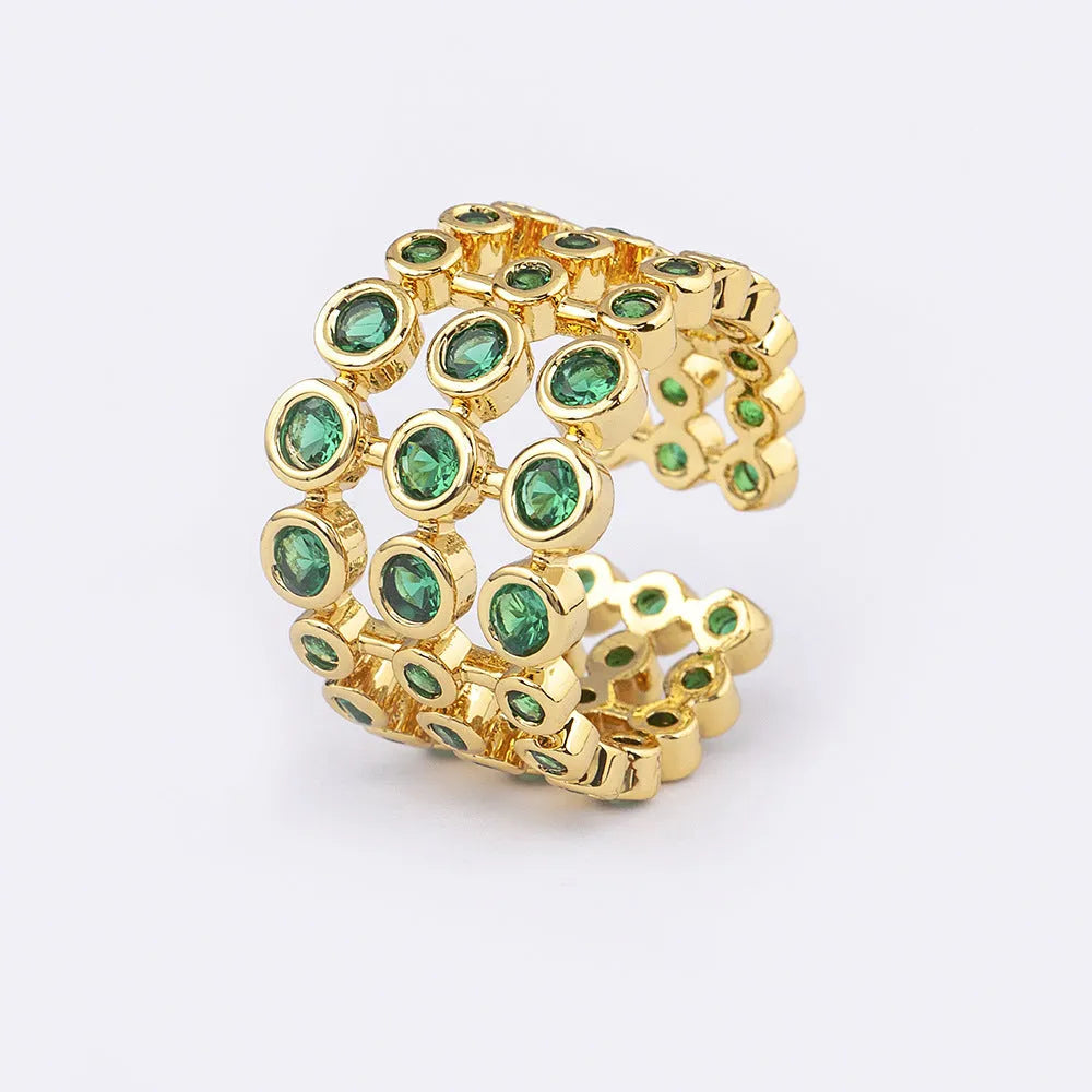 Wide copper ring with layered gold plating and green zircon stones